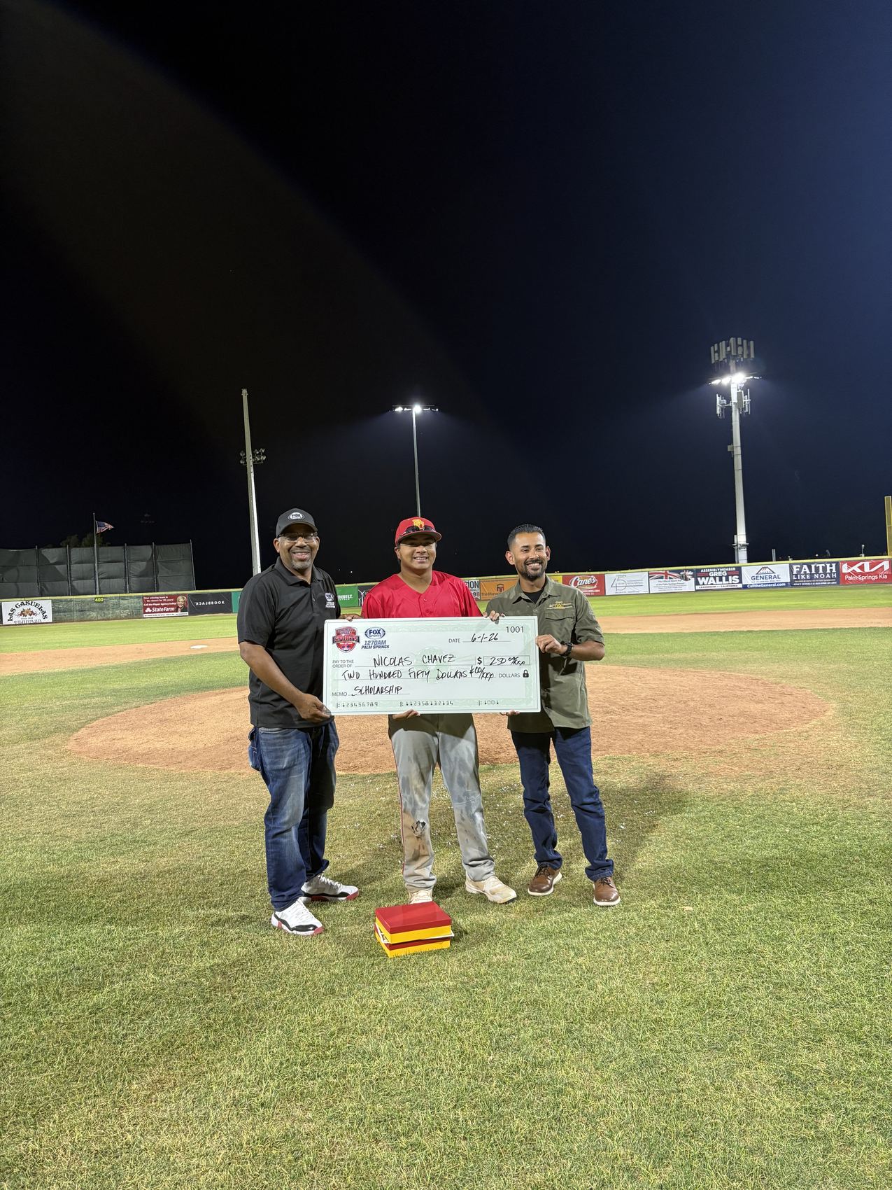 An association donation presented on the field at a youth baseball event